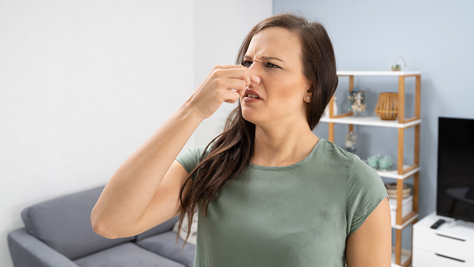 women hand on nose for foul smell