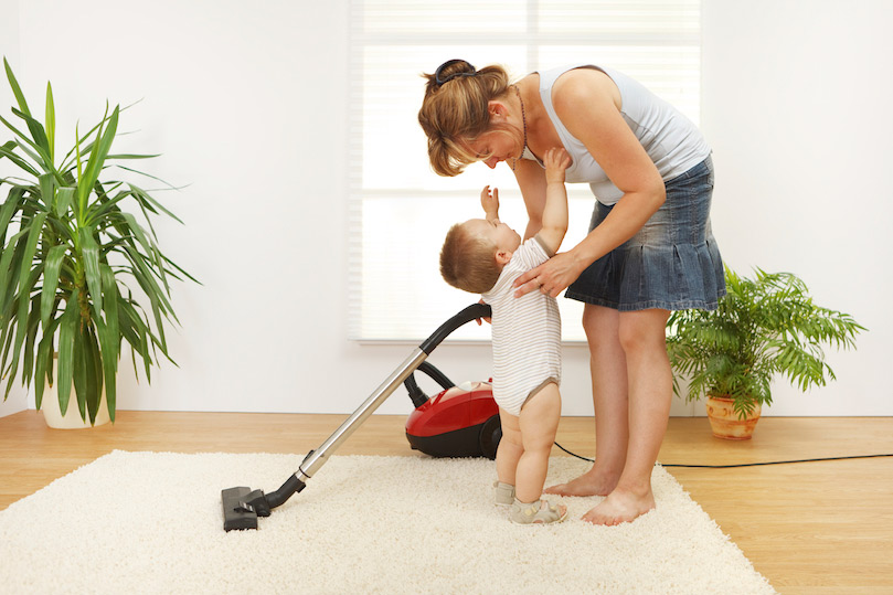 woman with her baby and cleaning house